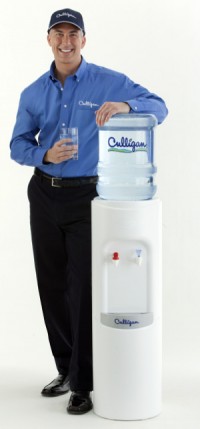 Culligan Man Standing by Bottled Water Cooler